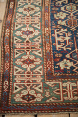 Section of antique Caucasian rug showing Kufic border, Koneghand patterns in madder red, jade green, sand.