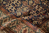 Intricate Koneghand and snake motifs in rich blues, reds, and greens on antique Caucasian rug.