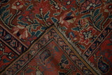 Folded antique Northwest Persian runner showing sprawling floral field and navy vine boteh border.