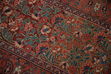 Ornate ruby red floral field, navy vine boteh border on antique Persian rug.