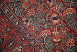 Antique Northwest Persian runner showing red floral bouquets, sprawling vines, and patterned border.