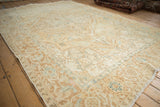 High angle view of a distressed Heriz rug showing its muted turtle border and low, even pile.