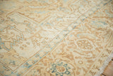 Close view of the distressed Heriz carpet's even wear, showing low pile in cream, sand, and blue.