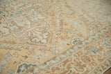 Evenly worn hand-knotted pile of a vintage Heriz rug in soft cream, sand, and dusty blue hues.