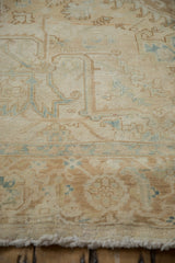 Angled view showing the even wear to the knot heads on the distressed Heriz carpet.