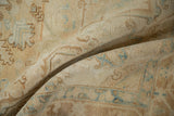 A soft fold shows the even, textural wear on a vintage distressed Heriz carpet pile.