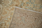 Reverse view of a vintage Heriz carpet showing the dense hand-knotted foundation and secured edge.