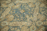 Close view of sprawling Seichor medallions and worn texture on a vintage hand-knotted Kurdish carpet.