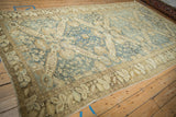 Angled view of a large distressed Kurdish carpet highlighting its allover Seichor design.