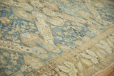 Worn, low pile texture of a vintage Kurdish carpet with sprawling medallions in dusty denim blue and sand.