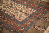 Repeating boteh motifs within the camel main border of an antique Serab runner.
