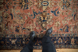 Close view of the even, time-softened wear on a copper and navy blue Lilihan carpet.