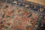 Evenly worn pile of an antique Lilihan carpet showing its copper field and navy floral border.