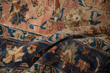 Intricate hand-knotted blossoms and vines in copper, navy blue, and sand on a textured Lilihan carpet.