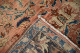 Corner of an antique Lilihan rug folded back to show the hand-knotted foundation and pile.