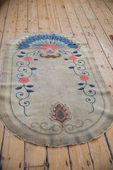 Border detail of the antique Chinese Art Deco rug with blush flowers and cobalt blue scrolled vines.