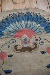 Detail of Art Deco Fetti-Li rug, showing brown scrolled contour, delicate blue vines, and blush florals.
