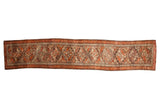 Vintage Kurdish rug runner with repeating geometric guls in dusty rust, brown, and silver.