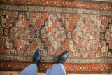 A view showing the mostly even wear and repeating geometric guls on a vintage Kurdish runner.