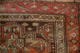 The serrated vine border and overcast stitch on the corner of a vintage Kurdish runner.