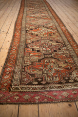 Repeating guls and a serrated vine border pattern the full length of a vintage Kurdish runner.