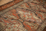 Mostly even wear across the knot heads of a vintage Kurdish rug with geometric guls.
