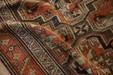 Detail of the serrated vine border and geometric guls on a low-pile vintage Kurdish runner.