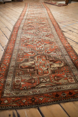 Low angle view of the long vintage Kurdish runner with its rust and brown geometric design.