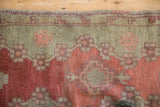 A close-up view showing the even wear to the knot heads of an antique Turkish Oushak rug.