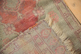 Evenly worn pile and hand-knotted foundation on a folded corner of an antique Oushak rug mat.