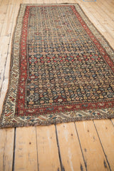 Secured end and low pile of an antique Qashqai runner, detailing the boteh and floral border motifs.