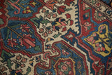The even wear on the hand-knotted pile of a vintage Baktiari rug with intricate floral motifs.
