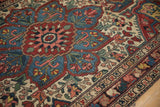 Angled view of the Baktiari rug's starburst medallion and wide floral color palette.