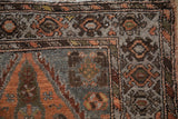 Vintage distressed Hamadan runner corner, showing geometric floral motifs in soft rust and pale chestnut.