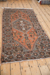 Distressed vintage Hamadan runner corner, fringe, and oxidized silver geometric border.