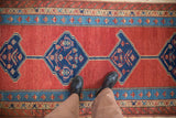 A view from above showing the bold blue medallions and hand-knotted texture of this antique Bakshaish runner.