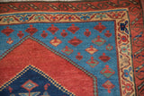 An antique Bakshaish rug corner showing the intricate serpent wave and meandering vine borders.
