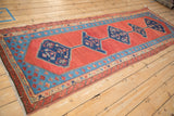 Angled perspective of the antique Bakshaish runner's interconnected blue medallions and detailed borders.