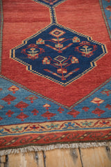 Reciprocating serpent wave border and hand-knotted fringe on an antique Bakshaish rug.