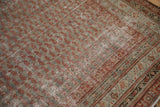Distressed antique Malayer carpet with faded ruby red boteh field and intricate dusty blue borders.