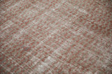 Distressed Malayer rug texture showing pale ruby red botehs and visible foundation.