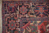 Vintage Ahar carpet: fringed edge, detailed border, brick red and navy floral field.