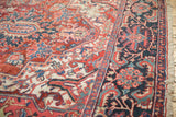 Vintage Ahar Carpet's intricate floral arabesques, vines, brick red field, and navy border.