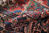 Hand-knotted vintage Ahar carpet's pile showcasing sophisticated floral motifs in rich gem tones.