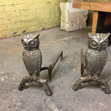 Pair of vintage whimsical owl andirons, crafted from textured silvery-grey metal with branch-like bases.