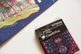 Black CoasterRug packaging with red, blue Qashqai-style coaster and white fringe.