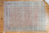Distressed hand-knotted Oushak carpet with allover salmon floral palmette design and blue borders.