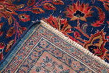 Antique Persian Kashan rug corner, revealing intricate knotting, fringe, and visible white knots.