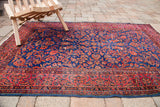 Antique Persian Kashan rug, rich royal blue and red curvilinear floral design, with aged patina.