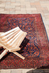 Intricately woven royal blue and rich red antique Kashan wool surface, showing characteristic white knots.